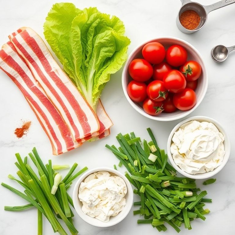 Raw ingredients for BLT cottage cheese bowl including bacon, cherry tomatoes, lettuce, cottage cheese, and green onions displayed overhead
