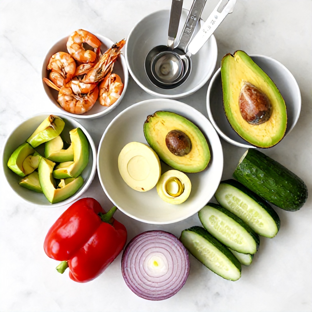 Raw ingredients for Grilled Shrimp and Avocado Bowl on a marble surface