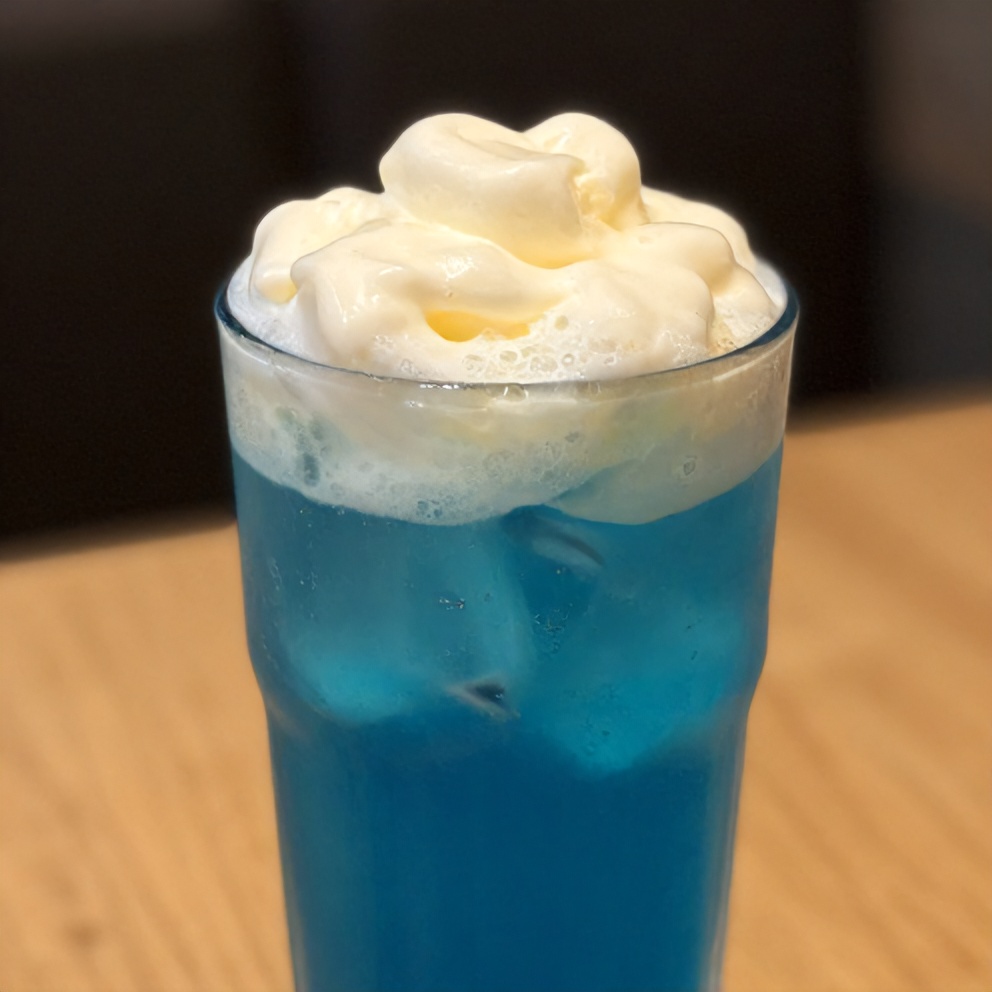 Iced Blue Tea Latte with Vanilla Cold Foam in a glass