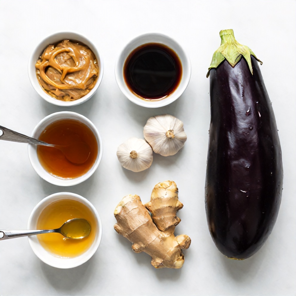 Miso paste, soy sauce, honey, garlic, ginger, and eggplant on a marble surface